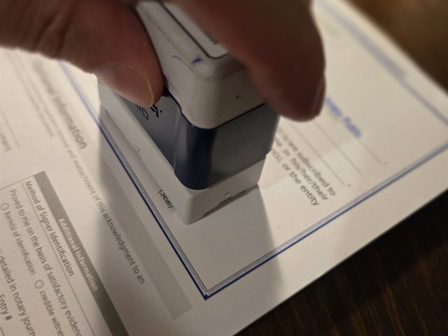 Notary stamping a document